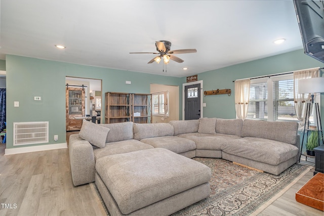 living area featuring recessed lighting, visible vents, a ceiling fan, wood finished floors, and baseboards