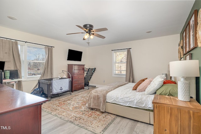 bedroom with ceiling fan and light wood-type flooring