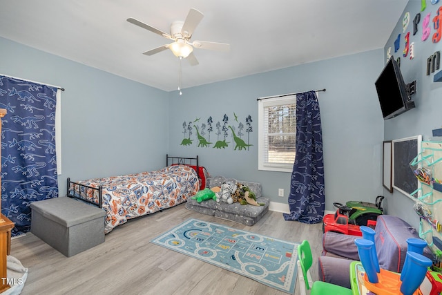 bedroom featuring wood finished floors and a ceiling fan