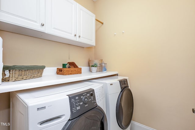 laundry room with cabinet space and washing machine and dryer