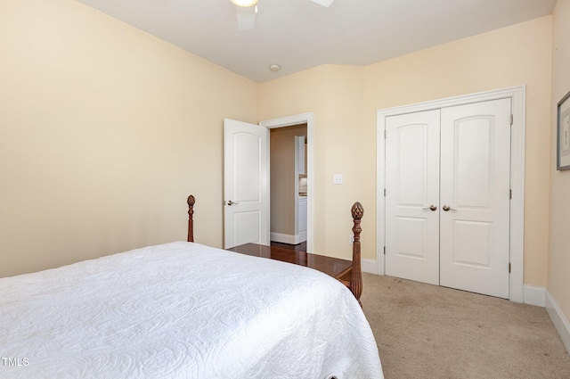 bedroom with baseboards, a closet, a ceiling fan, and carpet flooring