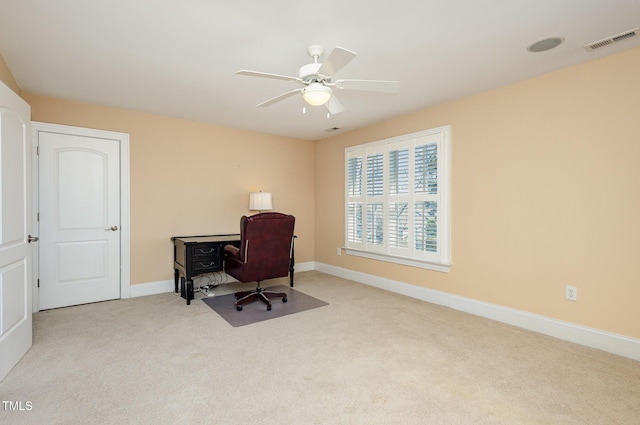 carpeted office featuring a ceiling fan, visible vents, and baseboards