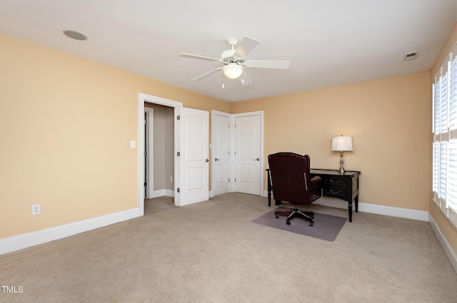 home office featuring carpet, visible vents, ceiling fan, and baseboards