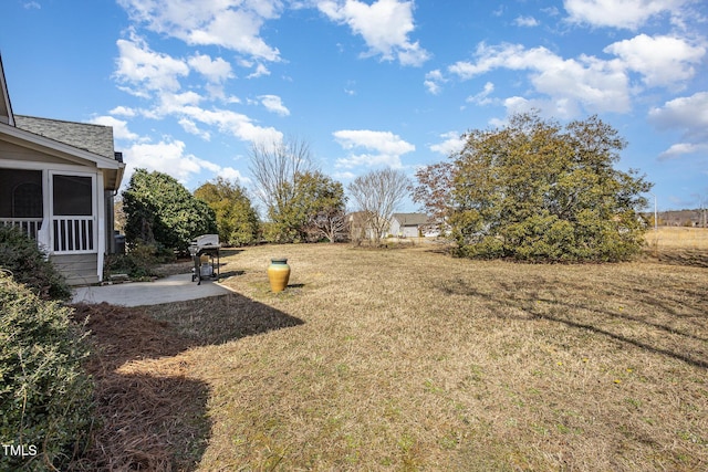 view of yard featuring a patio area and a sunroom