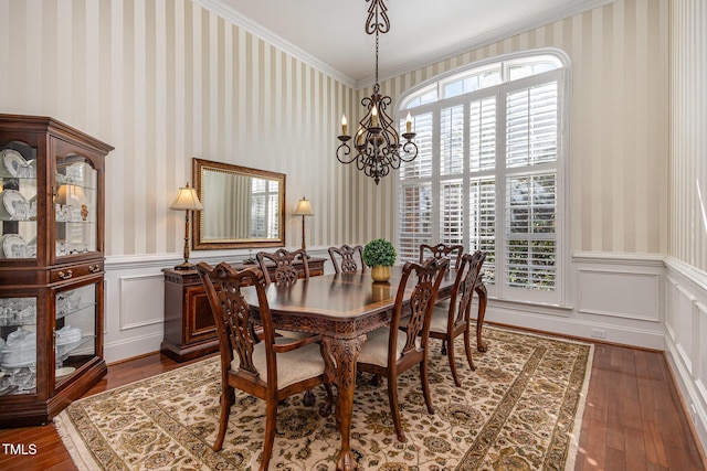 dining area featuring a wainscoted wall, a wealth of natural light, and wallpapered walls