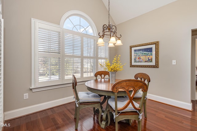 dining space featuring lofted ceiling, an inviting chandelier, baseboards, and wood finished floors