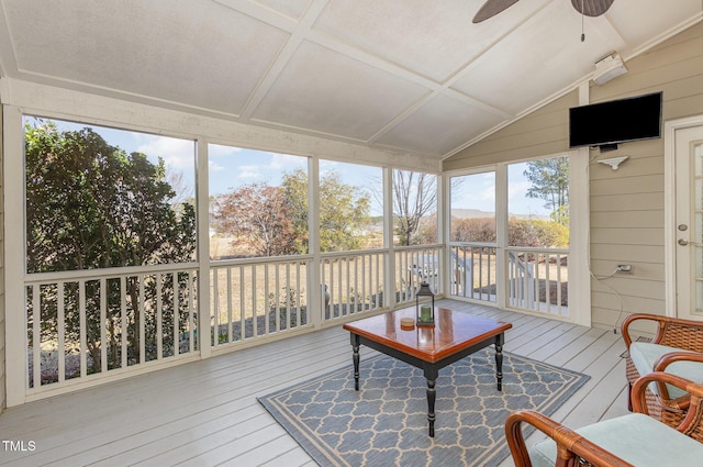 sunroom with ceiling fan and vaulted ceiling