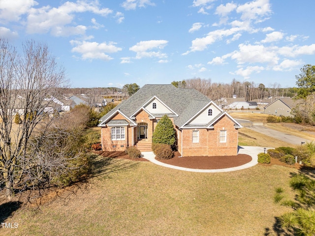 view of front of home with a front yard and brick siding