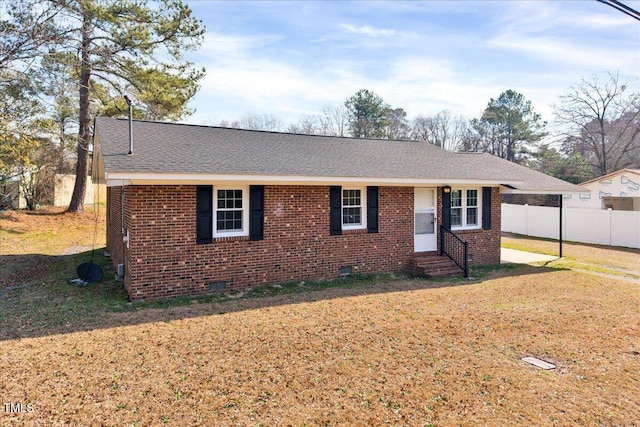 single story home with entry steps, brick siding, fence, crawl space, and a front yard