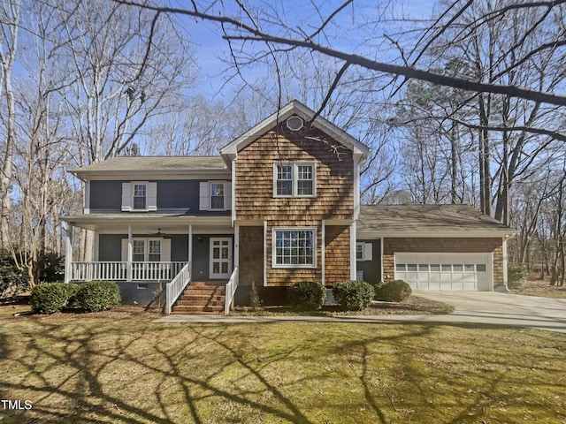 view of front of home featuring a garage, covered porch, driveway, and a front lawn