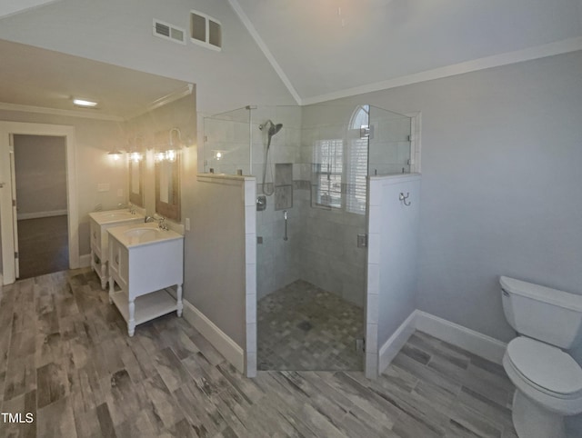 full bathroom with crown molding, a shower stall, toilet, and wood finished floors