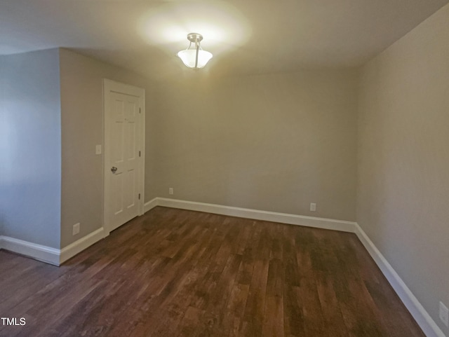 interior space featuring dark wood finished floors and baseboards