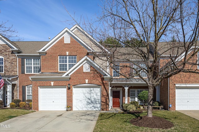 view of front of house with brick siding, driveway, and a front lawn