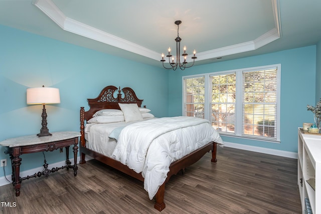 bedroom featuring baseboards, ornamental molding, dark wood-type flooring, a tray ceiling, and a notable chandelier