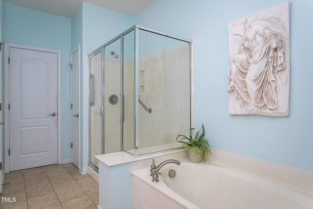 bathroom featuring tile patterned floors, a shower stall, and a bath