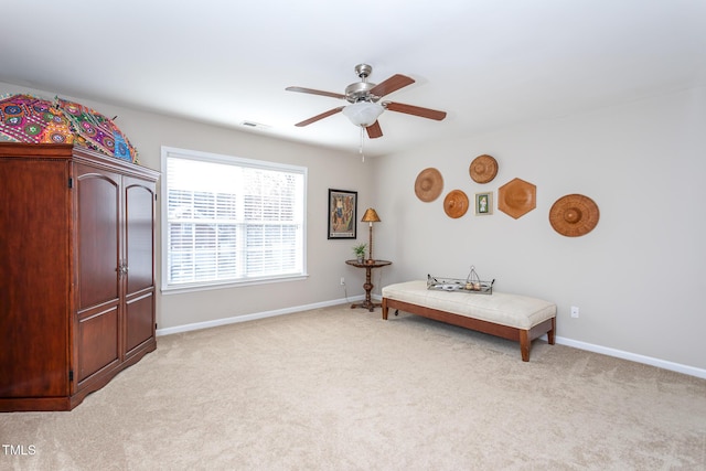 bedroom featuring light carpet, a ceiling fan, visible vents, and baseboards