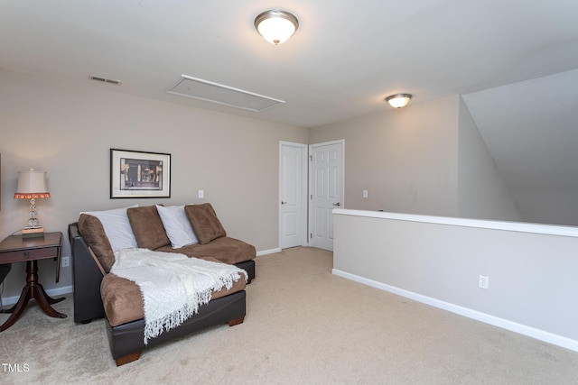 living area featuring light carpet, attic access, visible vents, and baseboards