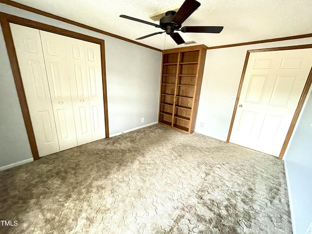 unfurnished bedroom with ornamental molding, a closet, carpet floors, and a textured ceiling