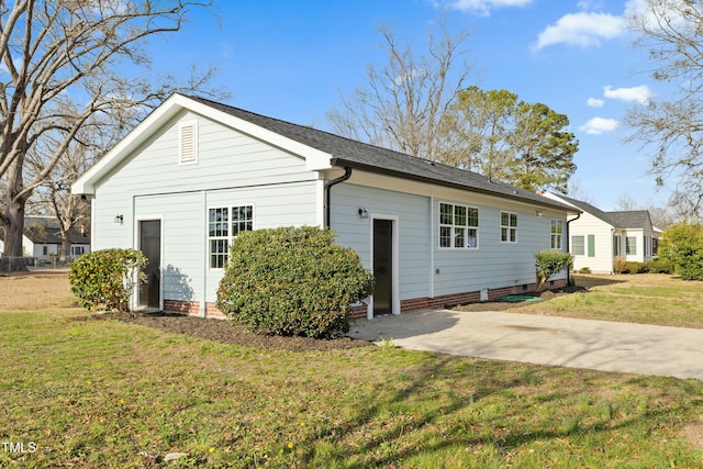 exterior space with crawl space and a lawn