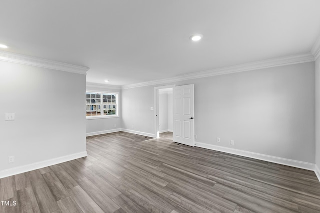 spare room featuring recessed lighting, dark wood-style floors, baseboards, and ornamental molding