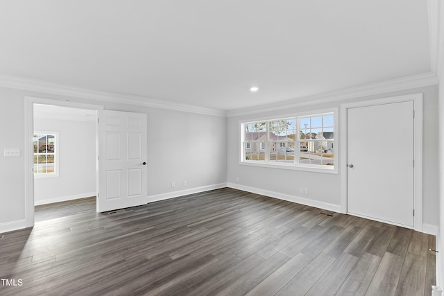 interior space featuring multiple windows, dark wood-type flooring, and ornamental molding