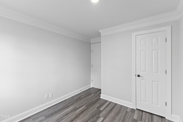 unfurnished bedroom featuring baseboards, dark wood finished floors, and crown molding