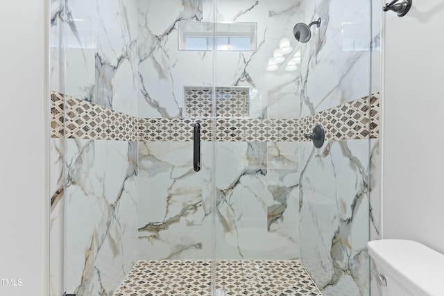 full bath featuring a marble finish shower and toilet