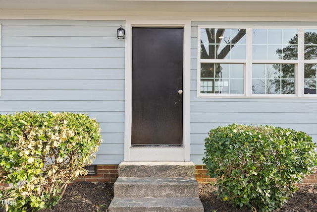 doorway to property featuring crawl space