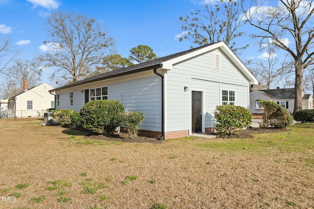 rear view of house featuring a lawn and an attached garage