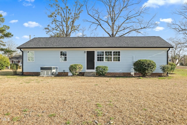 single story home with roof with shingles, central AC unit, a front lawn, and entry steps