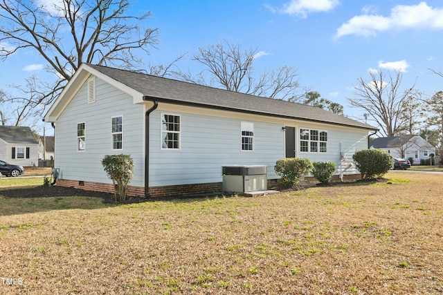 view of home's exterior featuring crawl space, cooling unit, and a yard