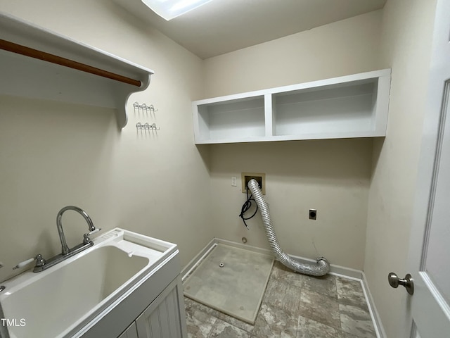 laundry room with baseboards, gas dryer hookup, laundry area, electric dryer hookup, and a sink