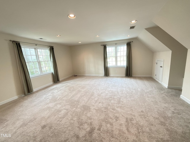 bonus room featuring baseboards, visible vents, recessed lighting, vaulted ceiling, and light carpet