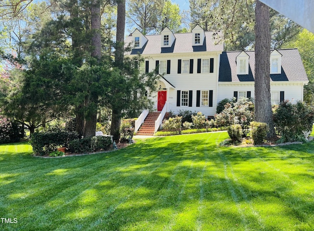 view of front of house with a front yard and a shingled roof