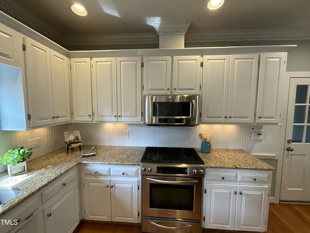 kitchen featuring white cabinets, light stone counters, and appliances with stainless steel finishes