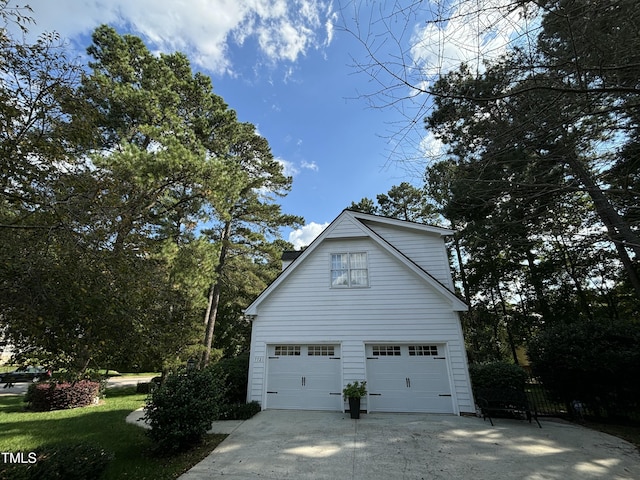 view of home's exterior with a garage and concrete driveway