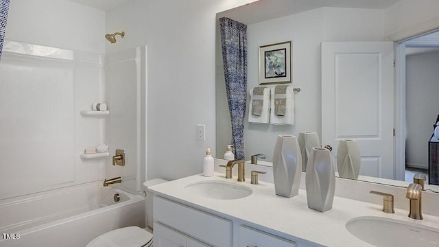 full bath with toilet, shower / tub combination, double vanity, and a sink