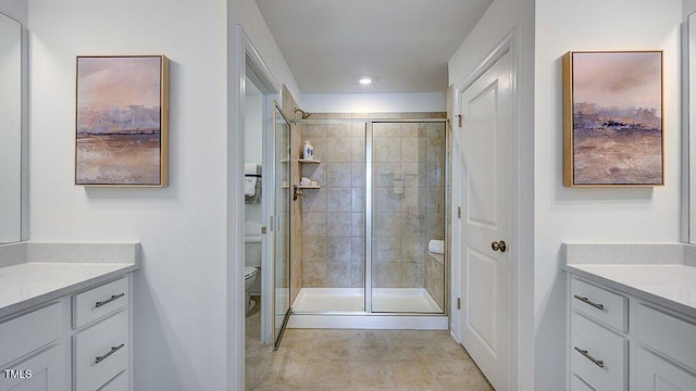 bathroom featuring a stall shower, vanity, toilet, and recessed lighting