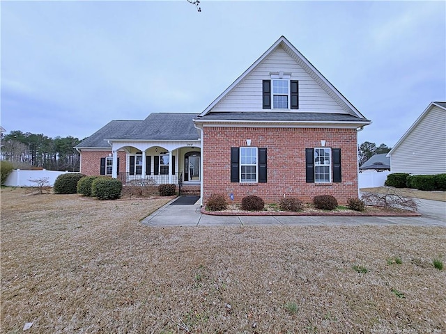 548 Windover Dr, Fayetteville, NC 28376 - traditional-style home with covered porch, roof with shingles, and brick siding