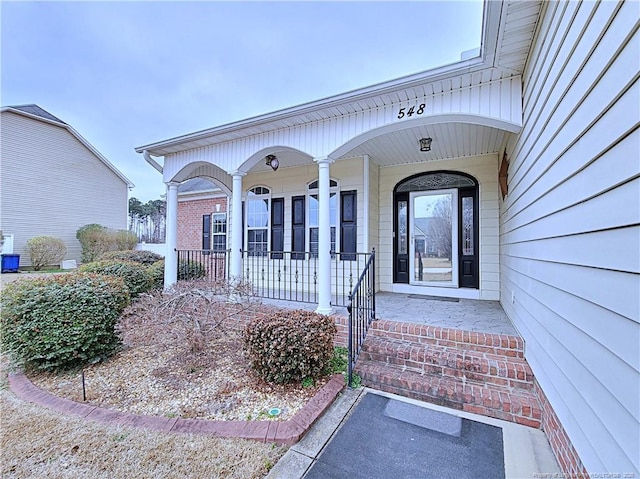 entrance to property featuring a porch