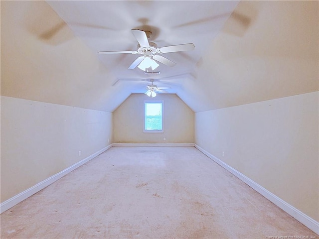 additional living space featuring lofted ceiling, light carpet, and baseboards