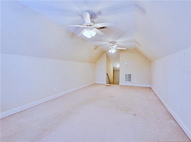 additional living space featuring vaulted ceiling, visible vents, and baseboards