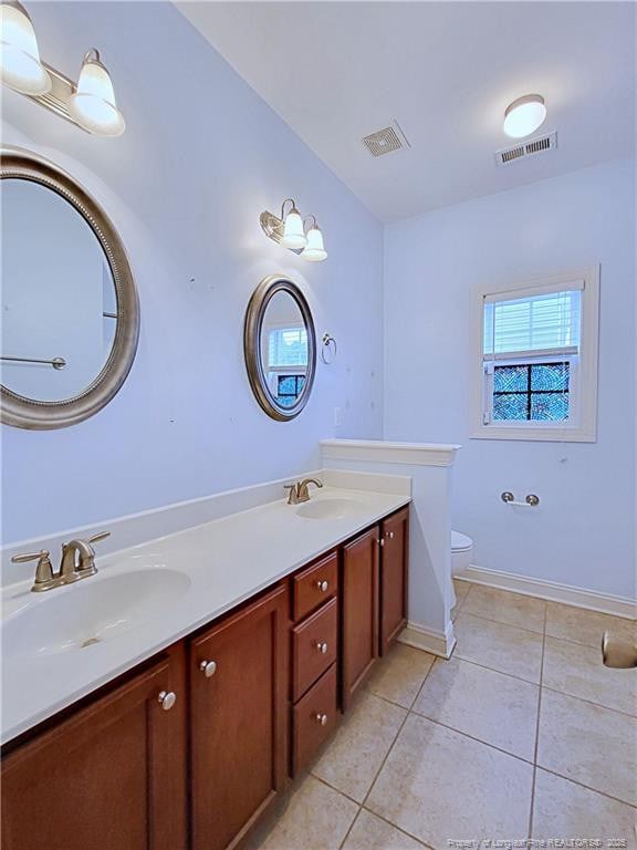 bathroom with toilet, tile patterned flooring, a sink, and visible vents