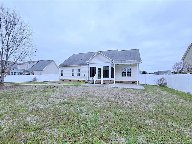 back of house with crawl space, a patio area, a fenced backyard, and a yard