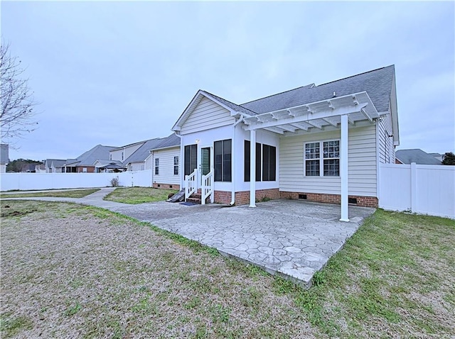 rear view of house with a yard, crawl space, a patio area, a pergola, and a fenced backyard