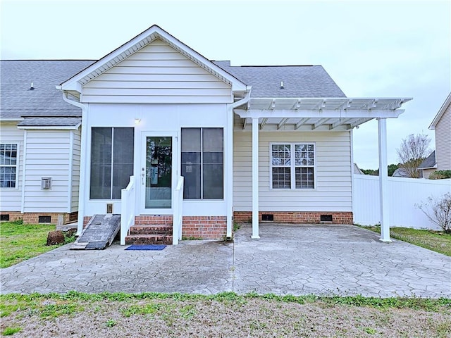 rear view of property with entry steps, crawl space, a patio area, and fence