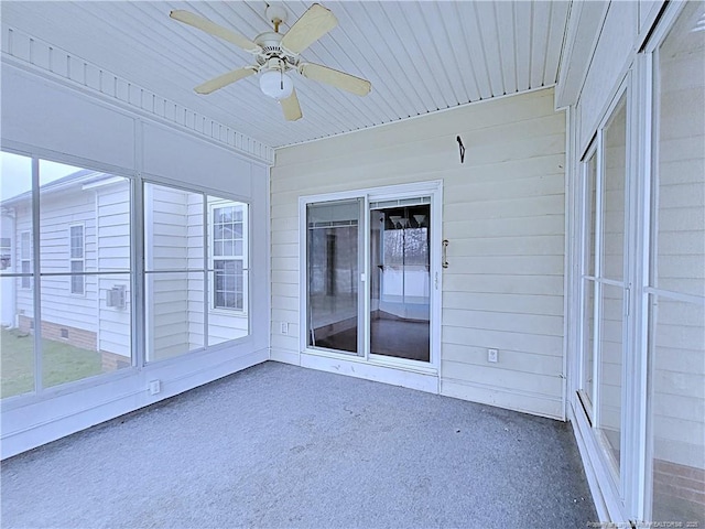 unfurnished sunroom featuring wooden ceiling and ceiling fan