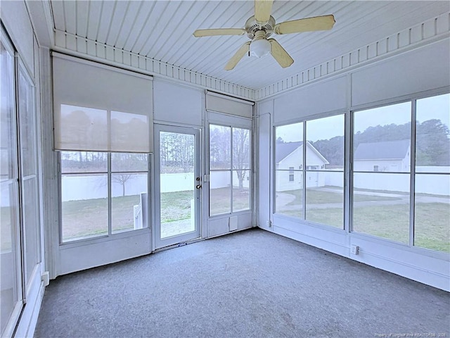 unfurnished sunroom featuring ceiling fan