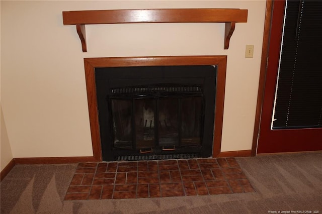 details featuring a fireplace with flush hearth, carpet flooring, and baseboards