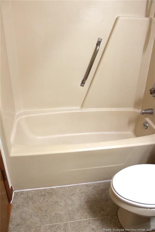 bathroom featuring  shower combination, toilet, and tile patterned floors